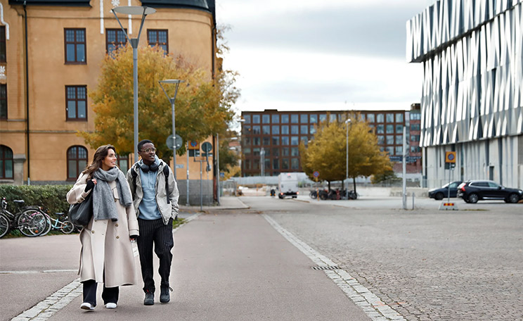 Kaksi nuorta kävelee vierekkäin kaupungilla