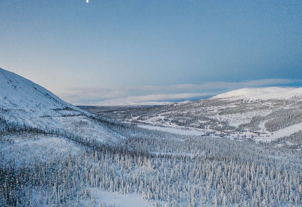 Avara maisemakuva Åren lumisista maisemista, kuvassa näkyy valkeita kukkuloita ja metsää