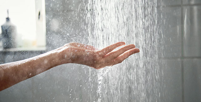 Käsi vesisuihkun alla