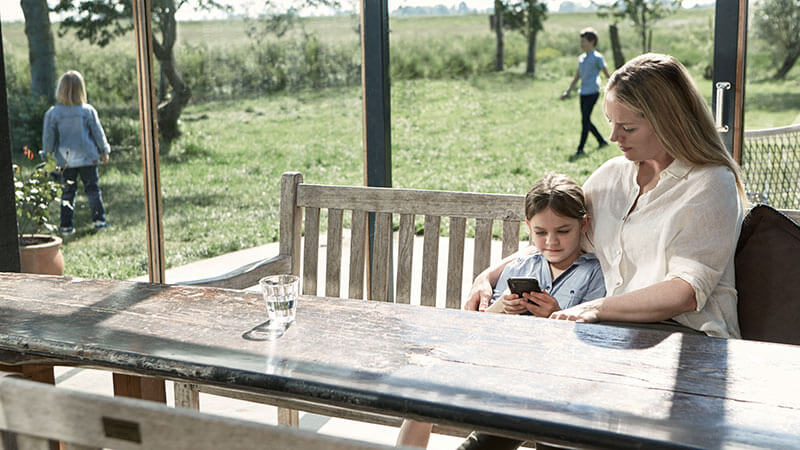 Mamma och dotter på en solig altan.